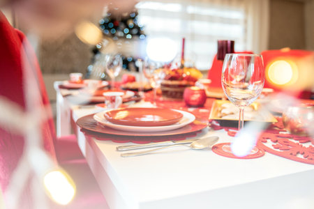 Photo of Christmas holidays red table setting concept. Festive dinner at home.の写真素材
