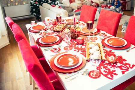 Photo of Christmas holidays red table setting concept. Festive dinner at home.