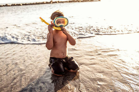 Vacation little boy in snorkeling mask having fun in water during summer holiday.の写真素材