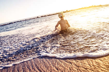 Vacation little boy in snorkeling mask having fun in water during summer holiday.の写真素材