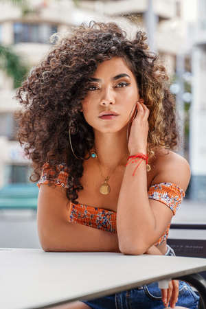 Beauty portrait of attractive colombian woman with afro hairstyle and delicate makeup posing...