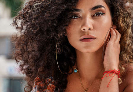 Beauty portrait of attractive colombian woman with afro hairstyle and delicate makeup posing...
