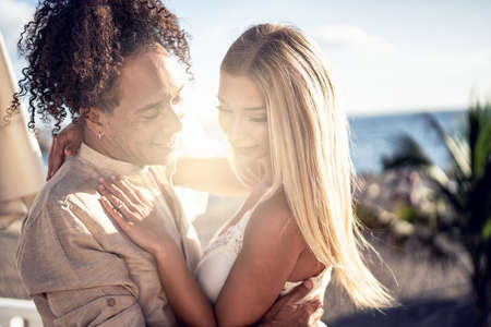 Beauty portrait of attractive couple embracing each other, dancing. Multiethnic people in love. Date. Wedding. Proposal. Real people emotions.の写真素材