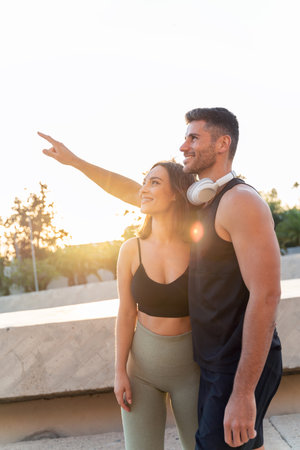 Powerful couple. Handsome man and beautiful woman in sport clothing resting after exercising outdoors. Fitness couple. Healthy lifestyle conceptの写真素材