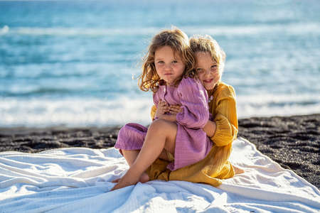 Two little cute sisters on the beachの写真素材