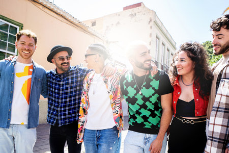 Fashionable group of happy multicultural friends having fun together, smiling and walking on the city street. Friendship. Real people emotions. Tourism. Travel.の写真素材