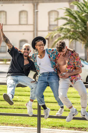 Three young fashionable crazy friends having fun together, laughing. Students. City break. Real people lifestyle.の写真素材