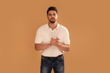 Young handsome fashionable man with beard looking at camera. Copy space. Studio shot.の写真素材