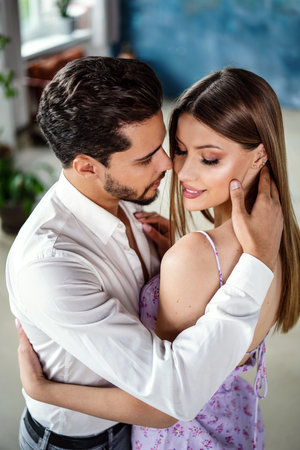 Beautiful couple in love posing together, hugging, dancing and smiling. Romantic date. Real people emotions. Closeup portraits.の写真素材