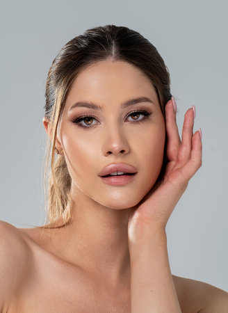 Photo of beauty face of the young attractive woman with a healthy skin and glamor delicate makeup. Closeup portrait of caucasian female. Skin care and beauty treatment concept.の写真素材