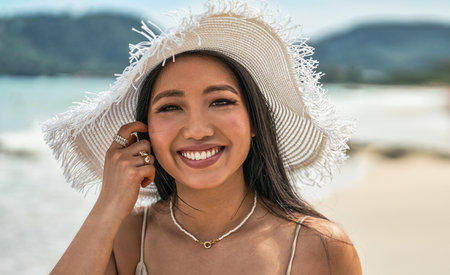 Asian woman wearing fashion summer beach hat for skin care sun protection. Beauty portrait on summer...