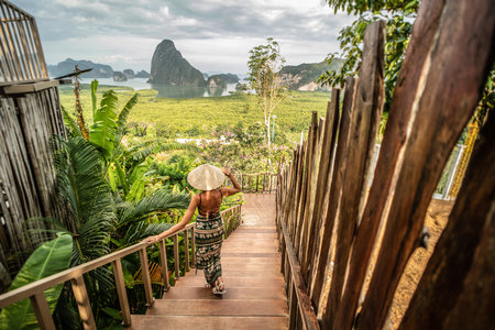 Solo traveler woman enjoying Phang Nga bay view point. Tourist at Samet Nang She, Thailand. Asia travel, trip and summer vacation concept. Full length photo. Wanderlust.の写真素材