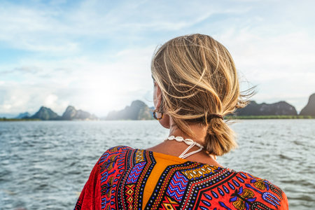 Tropical islands in Thailand. Woman looking at the landscape. Summer exotic holidays in Asia. back view. Phang Nga Bay.の写真素材