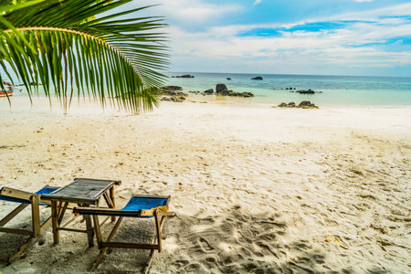 Paradise nature, sea water, tropical beach, sunbeds and palm trees. exotic island. travel destination. tourism.の写真素材