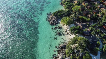 Turquoise colored ocean with little tropical beach and resort from above at the Island of Koh Lipe,...