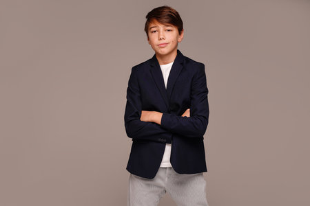 Elegant, fashionable and confident teen boy posing in studio, looking at the camera. A lot of copy space.の写真素材