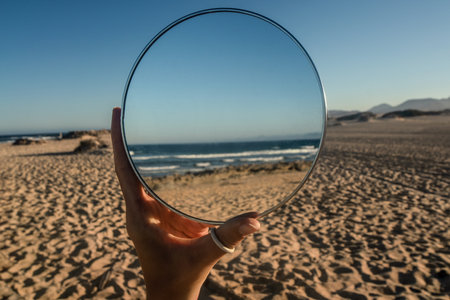 Conceptual photo of beautiful ocean coast with the sandy beach in the mirror reflection. dream. Nature. Summer. Fuerteventura.の写真素材