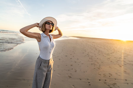 Portrait of calm, relaxed girl, carefree traveler woman enjoying summer vacation, walking on the sandy beach. Summertime, freedom concept. Copy space.の写真素材