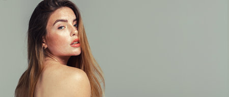 Natural woman with naked shoulders .Young beautiful woman with freckles. female beauty. copy spaceの写真素材