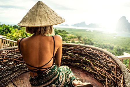 Traveler woman enjoying Phang Nga bay view point. Tourist at Samet Nang She, Thailand. Asia travel, trip and summer vacation concept. Back view. Wanderlust.の写真素材