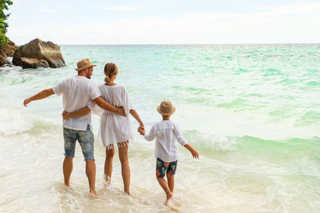 Tropical summer vacations. Happy family having fun together on the beach. Father, mother, son holding hands. Thailand, Koh Lipe.の写真素材