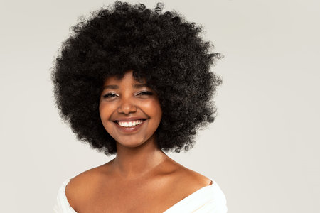 Happy african american woman smiling. Beauty female portrait. Young emotional afro woman. The human emotions, facial expression concept.の写真素材