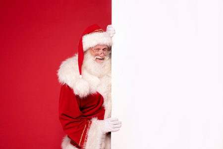Portrait of real happy Santa Claus with white empty board. Christmas are coming!の写真素材