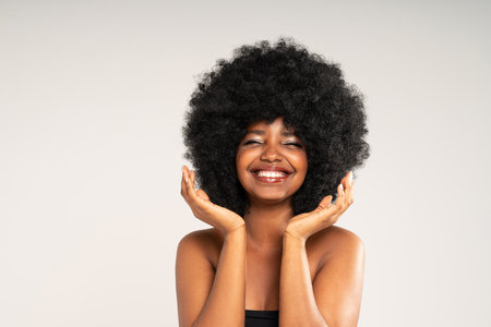 Happy african american woman smiling. Beauty female portrait. Young emotional afro woman. The human emotions, facial expression concept.の写真素材