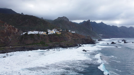 Panoramic aerial view of wild coastline with big waves on the north coast of the island Tenerife, Spain. Little village in the mountains. Travel destination.の写真素材