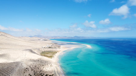 Aerial drone shot from Canary islands. Sotavento beach on the coast of Fuerteventura island. Natural sunny light. Blue sky and dunes. Coastline. Top travel destination.の写真素材
