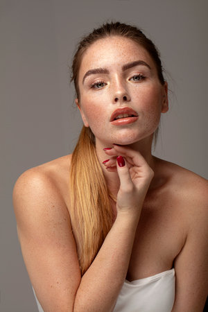 Beautiful natural woman with freckles on face and body, delicate look.の写真素材
