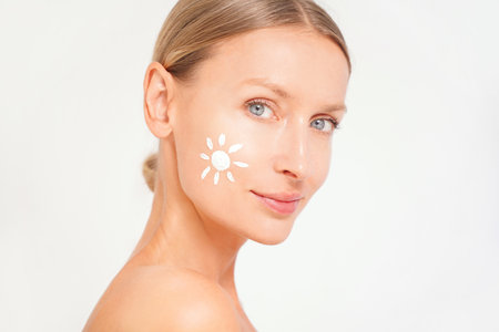 Beauty woman face with spf sunscreen. Skincare treatment, facial lotion anti aging. Conceptual photo.の写真素材