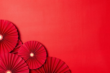Red paper fan on red background, Chinese new year celebration concept.の写真素材
