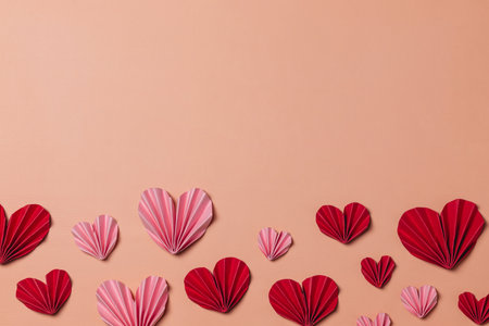 Valentine's day background with red paper hearts on a pink background