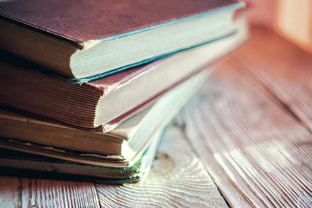 stack of retro books on wooden tableの写真素材