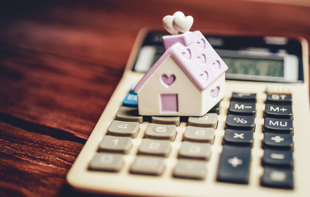 calculator and house on the table. The concept of saving for the house of your dreamの写真素材