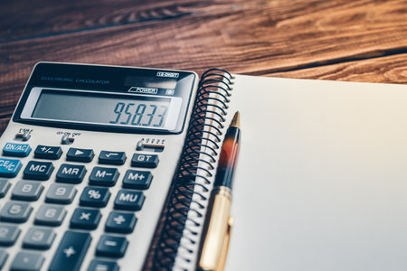 close up of calculator, pen and notebook on a wooden background. Concept of business, finance, educationの写真素材