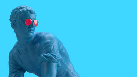 3d render male statue looking back over a blue background in glasses looks backの写真素材
