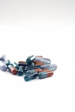 Pills in capsules at white blank  の写真素材