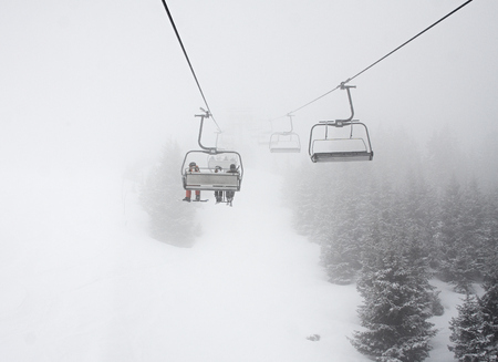 Cabins litfs at the mountains through fogの写真素材