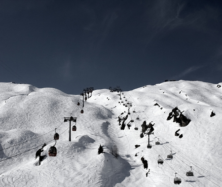 Snow slopes and lifts an mountains for ski and snowboard