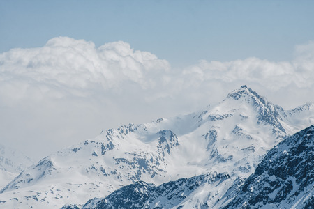 Mountain peaks at winter with snow and clear skyの写真素材