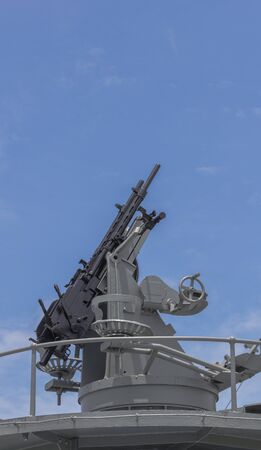 Machine gun on the deck of battleship with the blue sky background  This photo is taken from Battleship memorial at Samuthpraparn Thailand の写真素材
