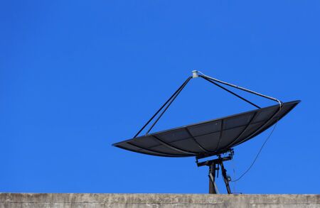 Satellite Dish with Blue Sky on Roof, Closeupの写真素材