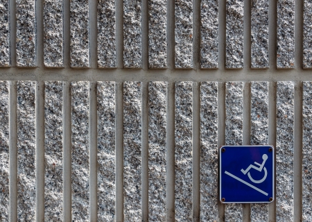 Ramp access sign for the disabled on concrete wall backgroundの写真素材