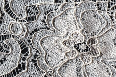 Lace with Flower Pattern on Black Background, Closeup
