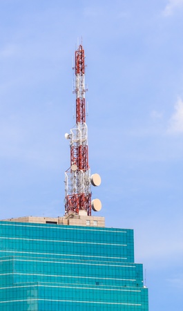 Telecommunication Tower with Antennas on the top of Glass Building Telecommunication Tower with Antennas on the top of Glass Building