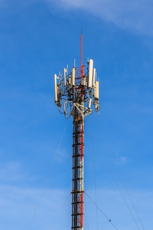 Telecommunication Tower with Antennas against Blue sky Background Telecommunication Tower with Antennas against Blue sky Background