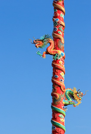 Twin Dragons on Red Pillar isolated on Blue Sky の写真素材