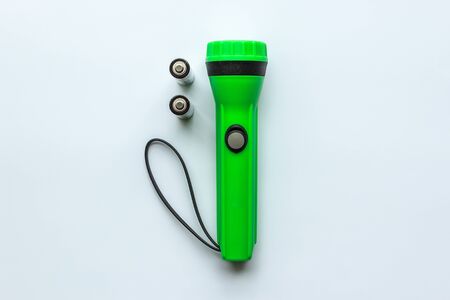 Green Flashlight with Battery on White Backgroundの写真素材